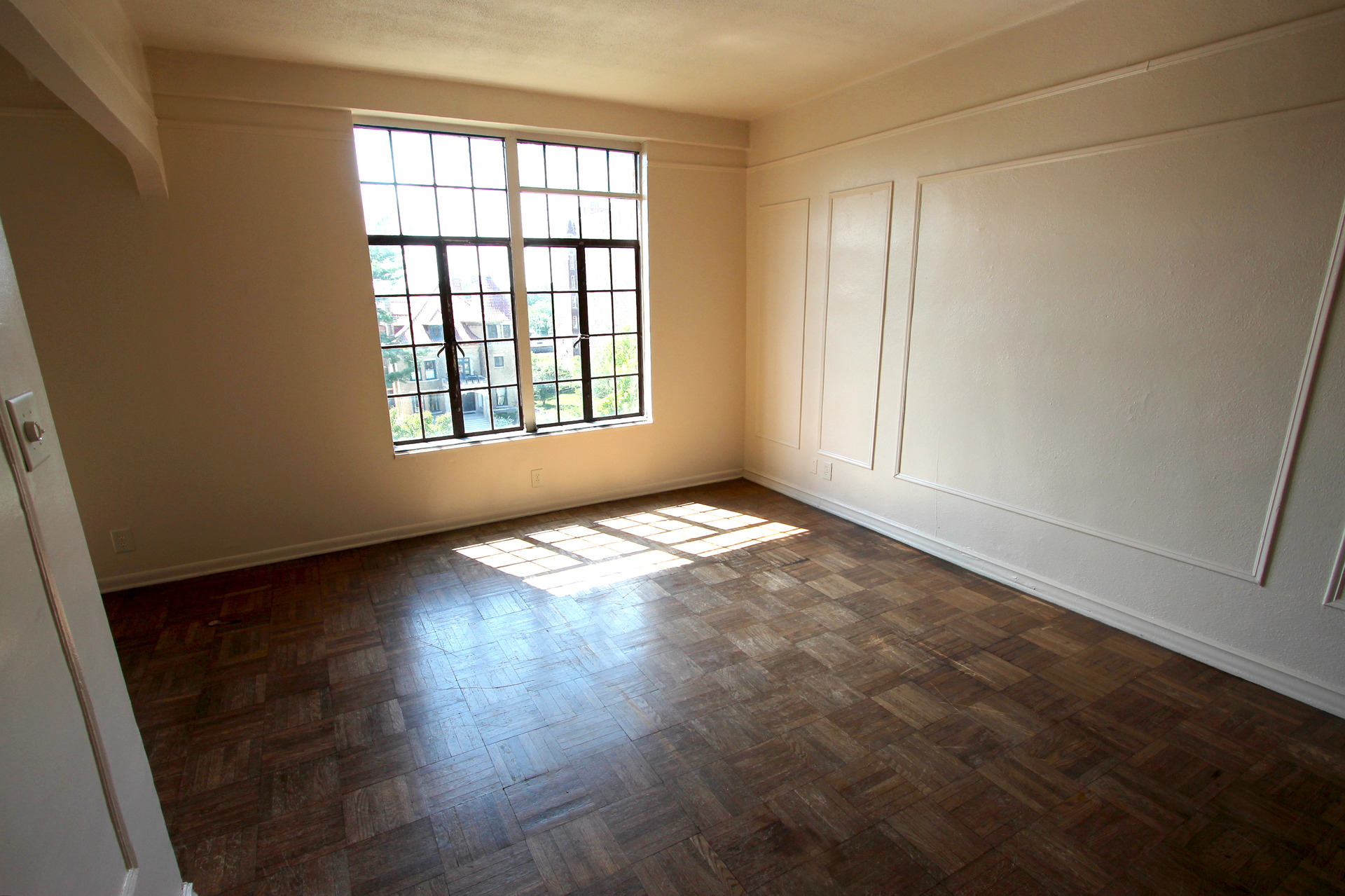 Apartment interior with window and parquet floors